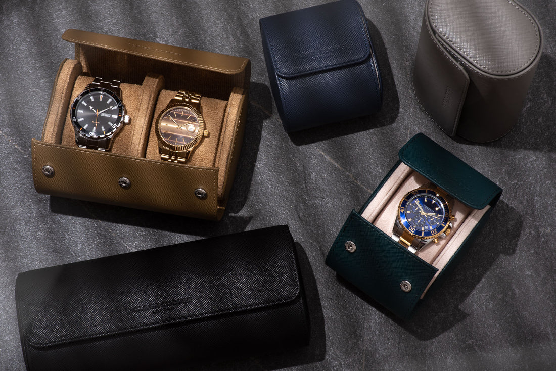  A group of Oliver Cooper London watch rolls in a variety of colors and sizes displayed on a table.