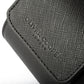 Close-up of a black leather travel watch case showcasing the saffiano leather pattern.