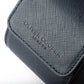 Close-up image of the navy blue saffiano leather case featuring the Oliver Cooper London logo.