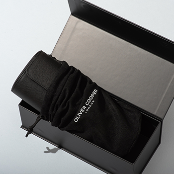 three watch roll presented in a black suede dust bag and black gift box 